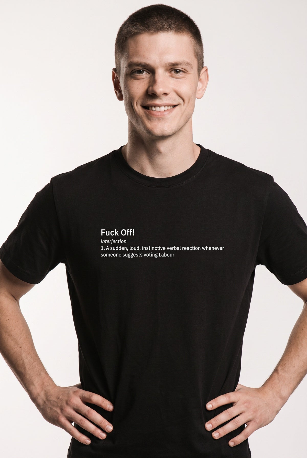 A smiling man wearing a black short-sleeve t-shirt with white printed text on the chest, posed against a light gray studio background.