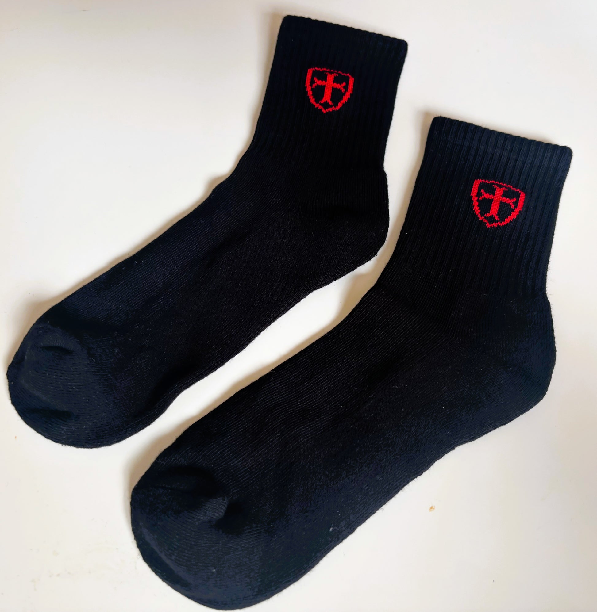 Pair of black socks with red logo