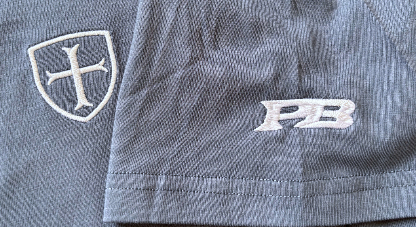 blue t-shirt with a white patriot logo