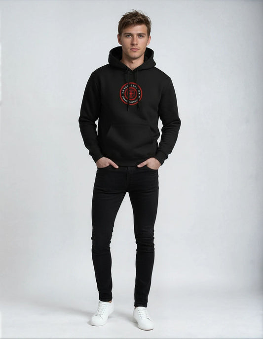 Man wearing a Paganus black hoodie with a red logo and black jeans on a white background