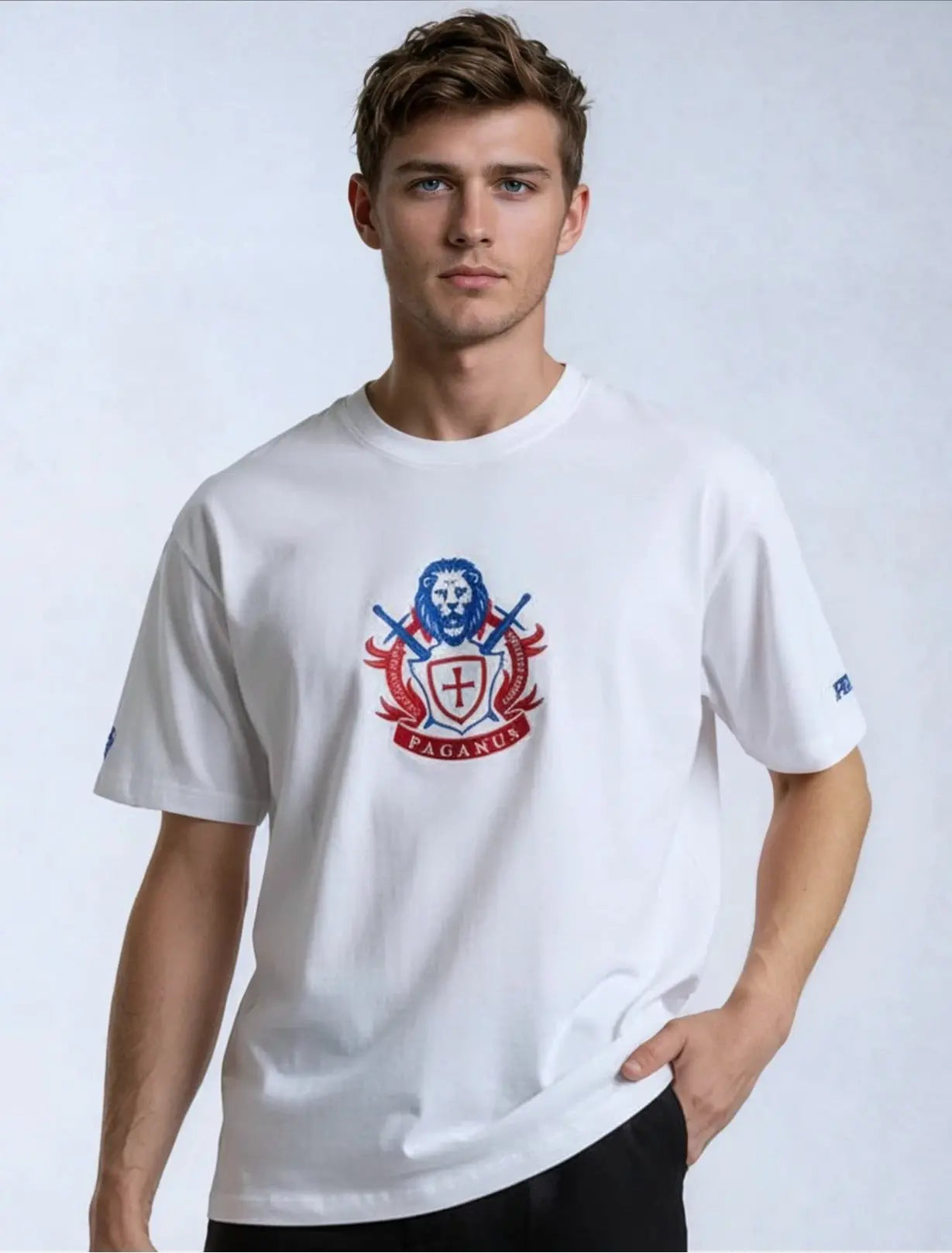 Man wearing a white paganus t-shirt with a patriot logo