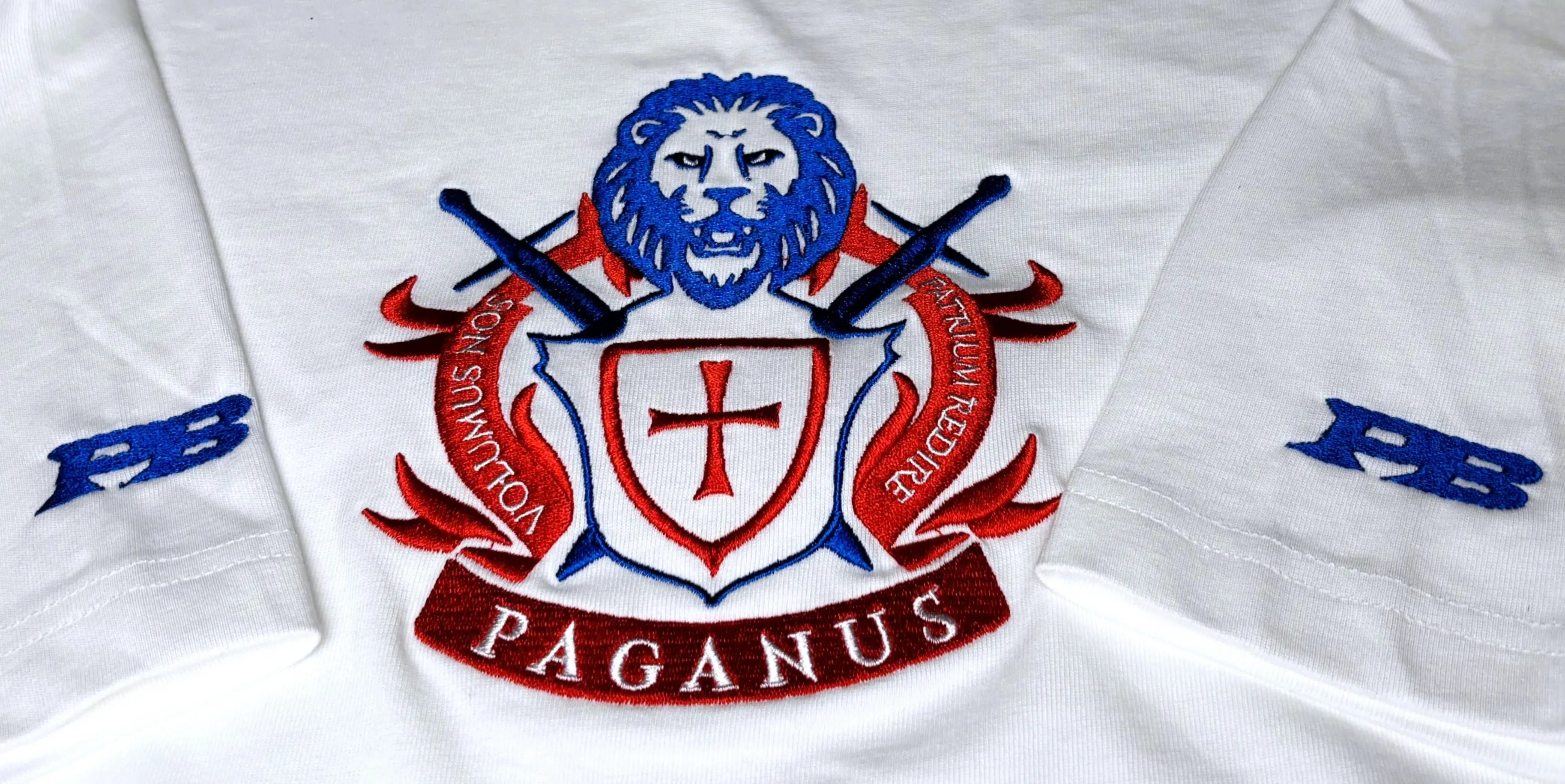 Man wearing a white paganus t-shirt with a patriot logo