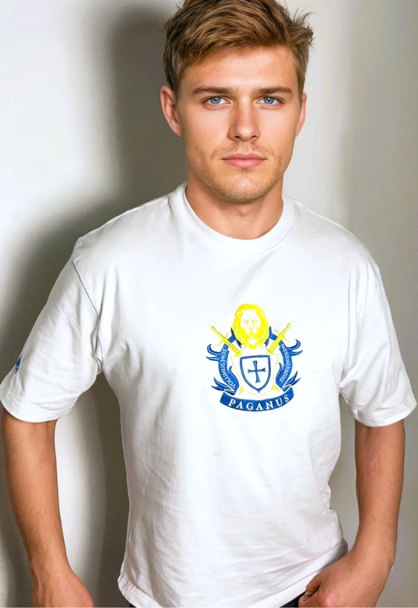 Man wearing a white t-shirt with a blue and yellow logo on a plain background