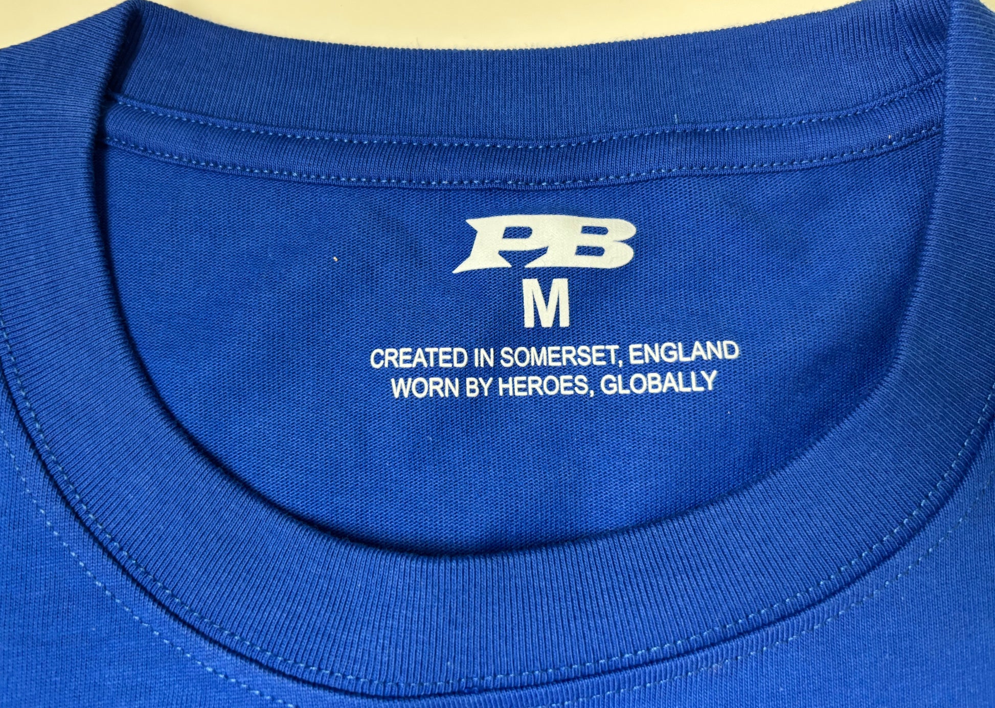blue t-shirt with a logo on 280gsm combed cotton t-shirt