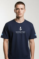 Man wearing a navy blue t-shirt with branding on a white background
