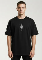 Man wearing a Paganus Britannia black t-shirt with a fuck you middle finger design in white silk  embroidery