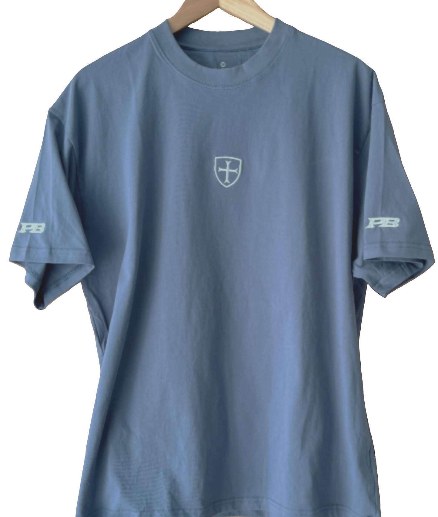 blue t-shirt with a white patriot logo