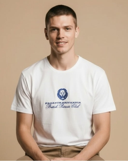 Man wearing a white t-shirt with a logo and text on a beige background