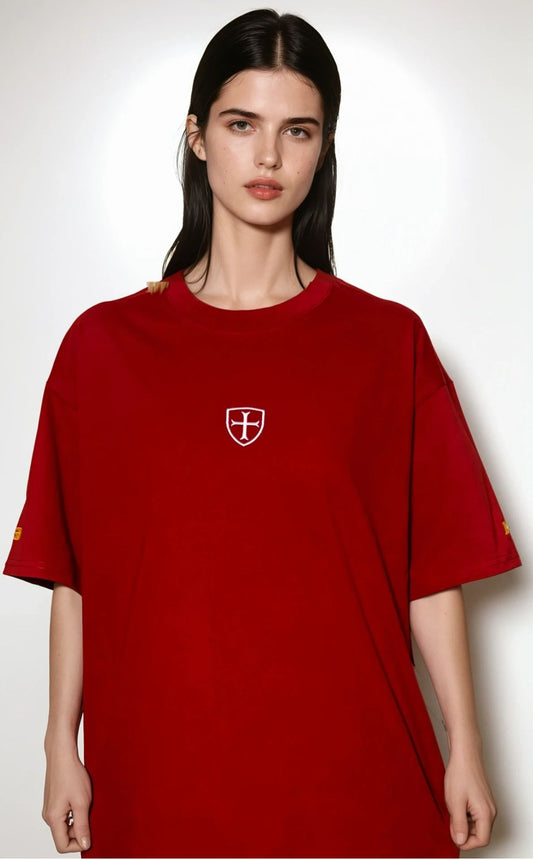 Woman wearing a red t-shirt with a white logo on a white background