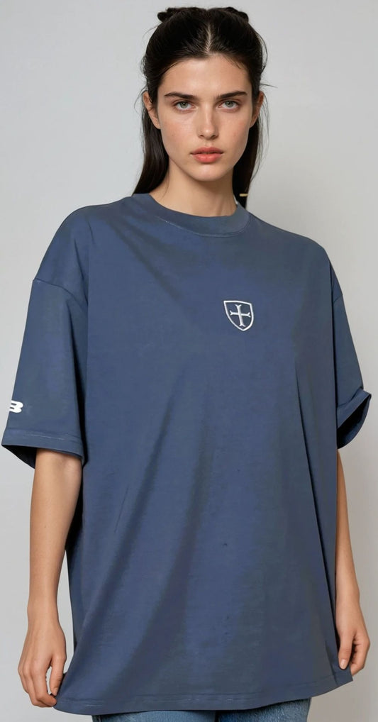 Woman wearing a blue t-shirt with a logo on a gray background