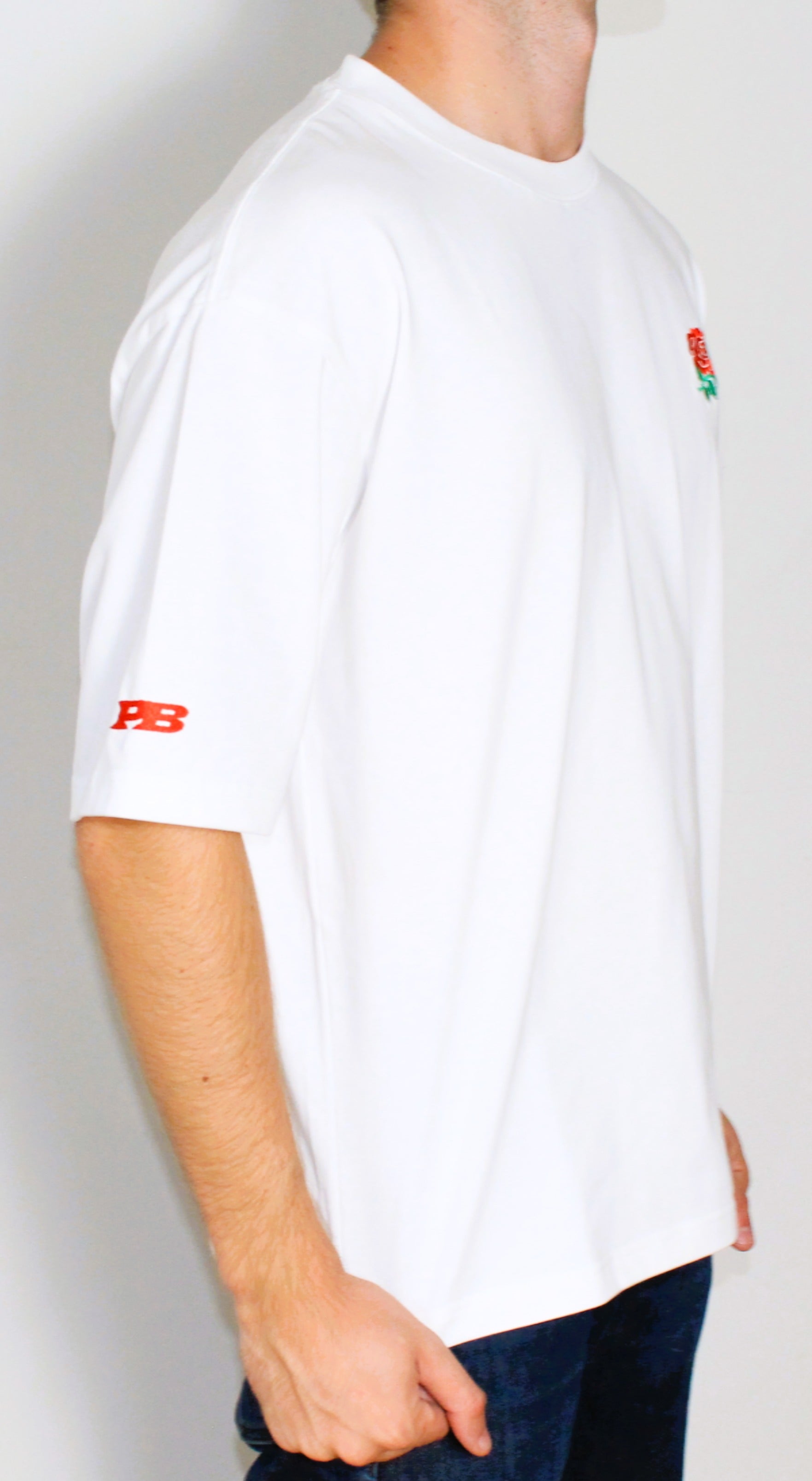 White t-shirt with red logo on a plain background