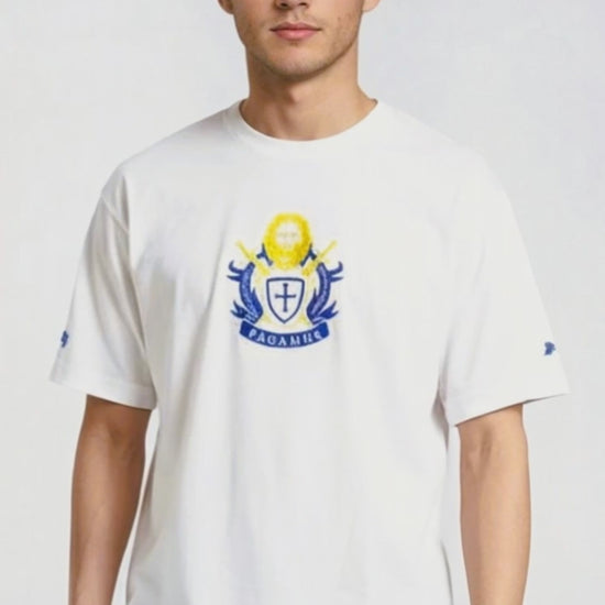 Person wearing a white Paganus t-shirt with a volumus nos patrium redire logo on a white background