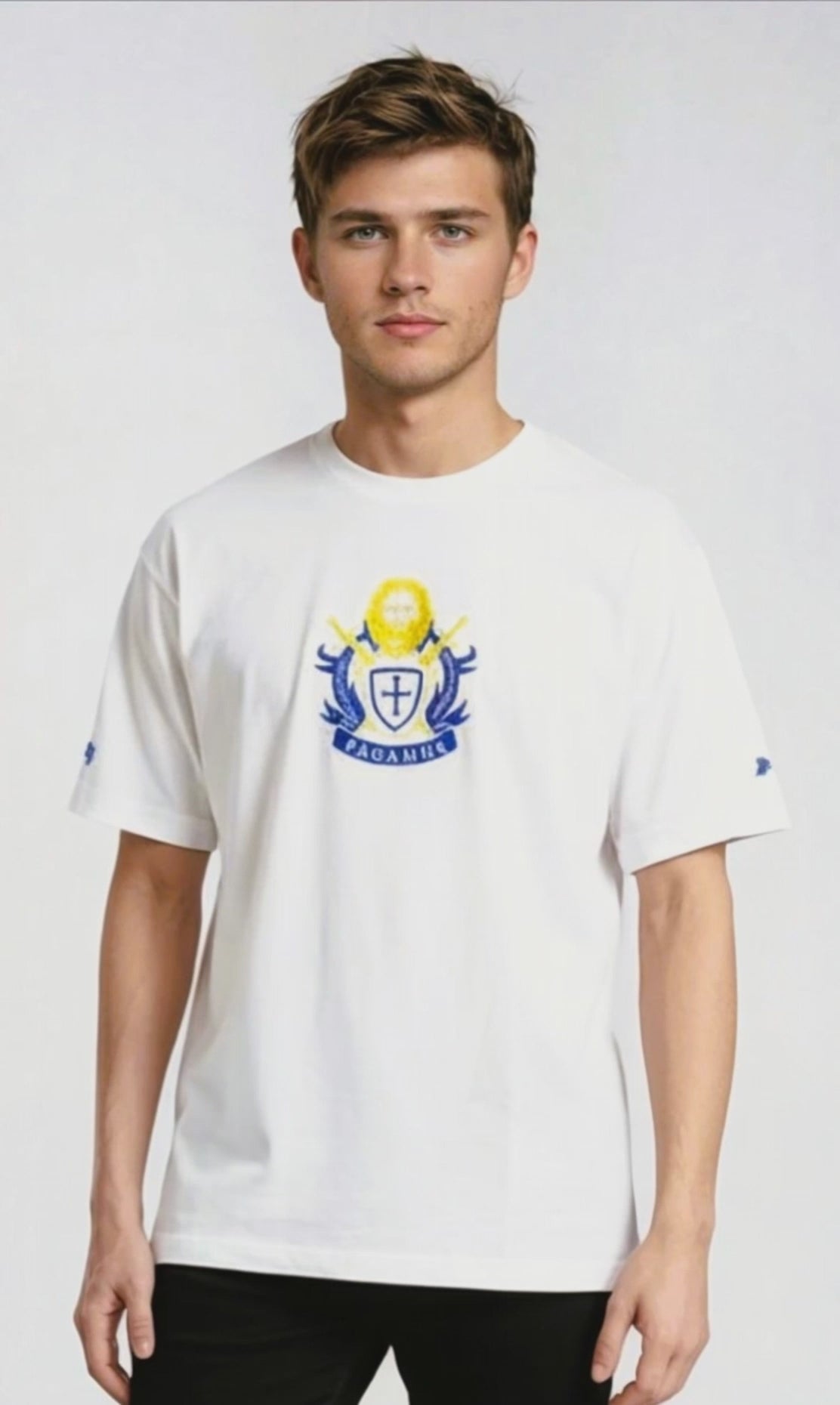 Person wearing a white Paganus t-shirt with a volumus nos patrium redire logo on a white background