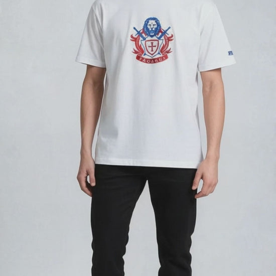Man wearing a white paganus  t-shirt with a patriot logo 