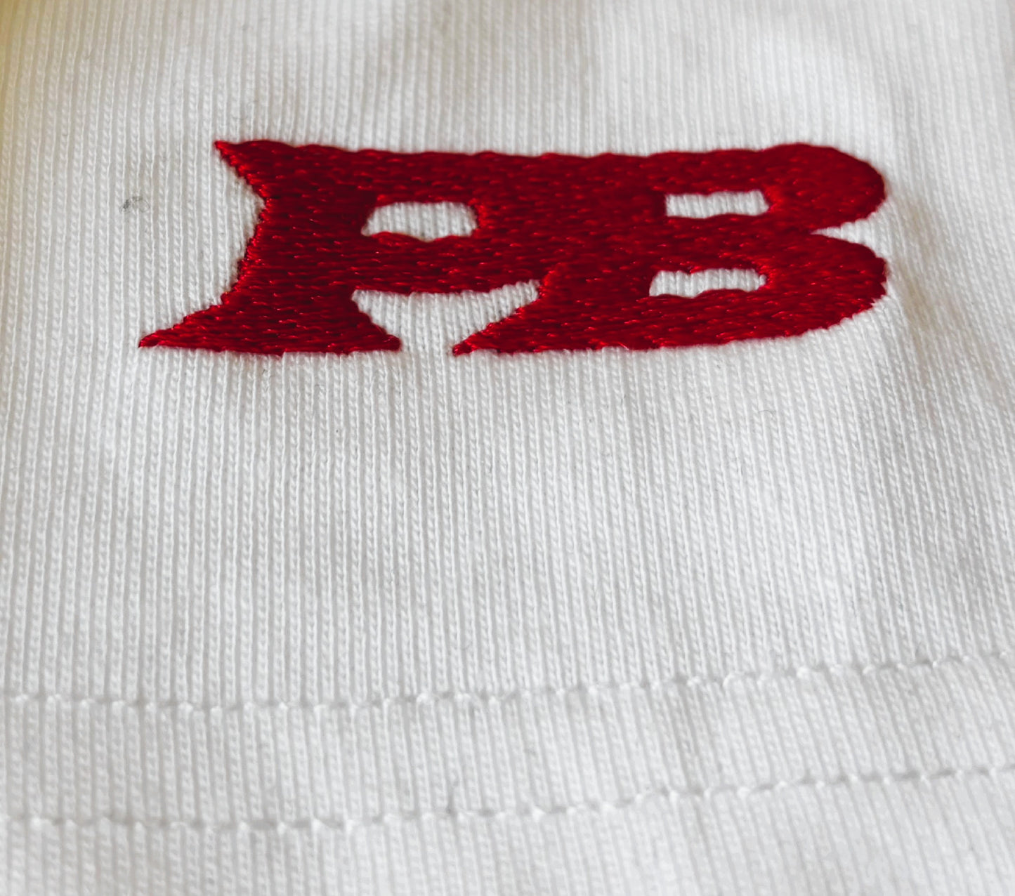 Red 'PB' logo on a white background