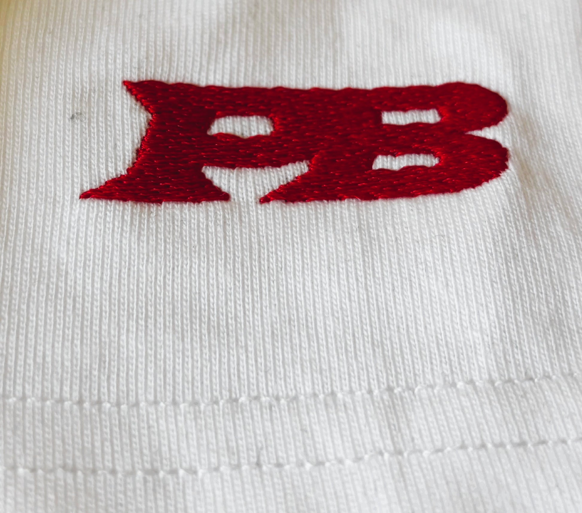 Red 'PB' logo on a white background