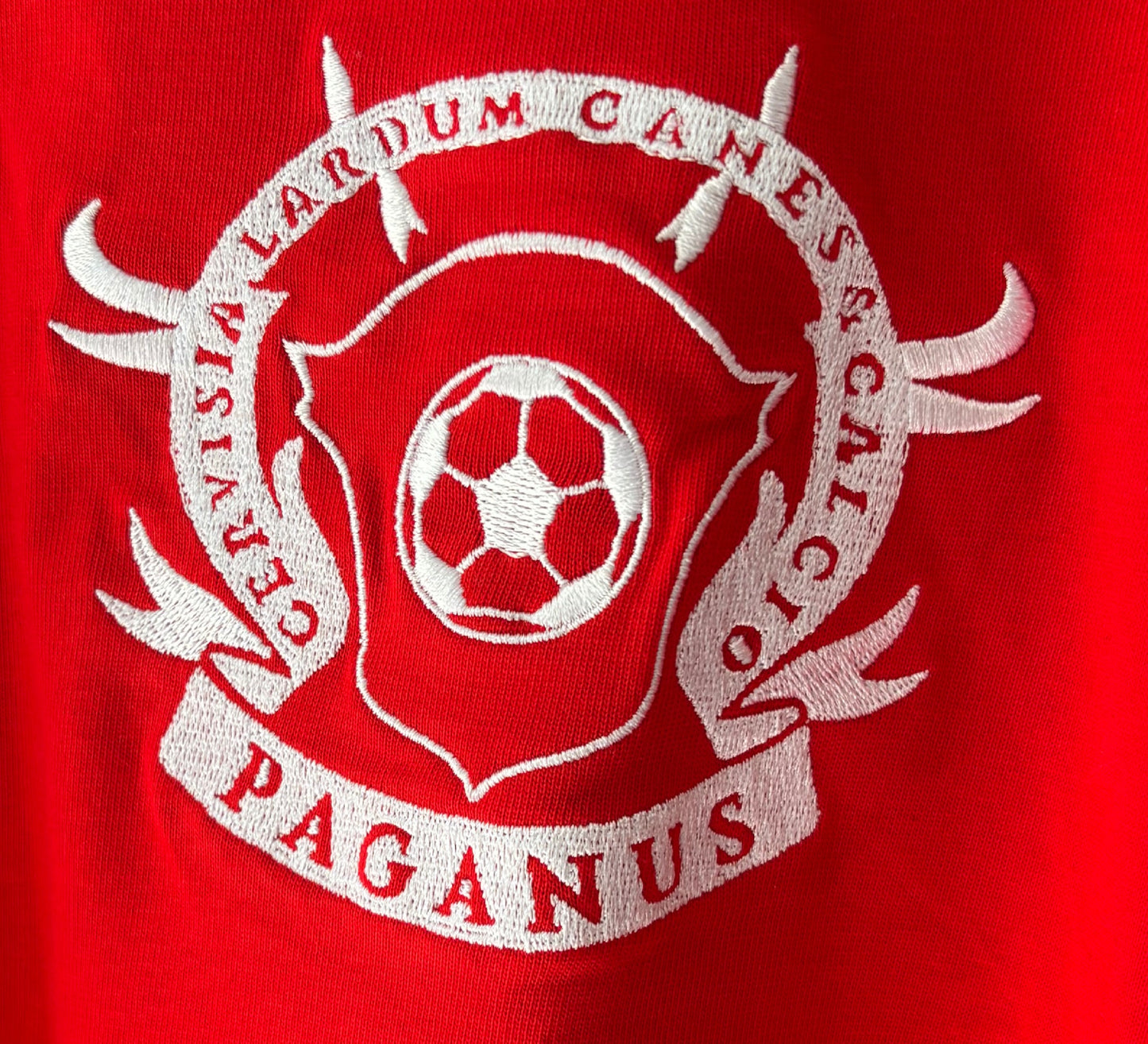 White logo with a soccer ball on a red background