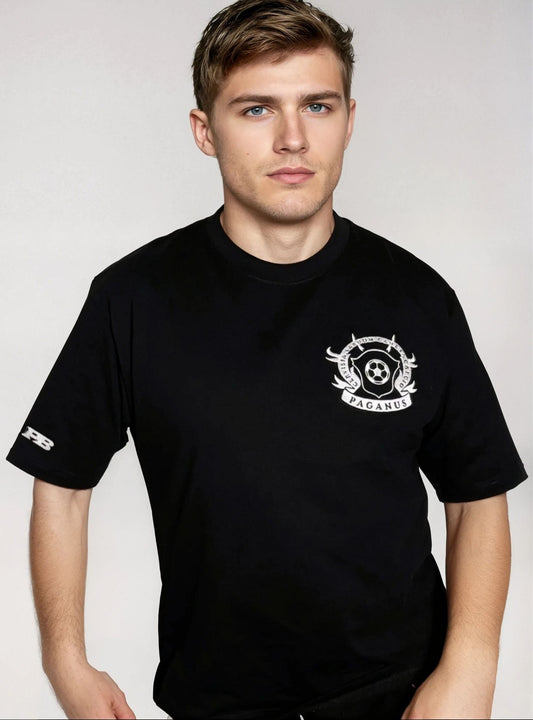 Man wearing a black t-shirt with a logo on a plain background