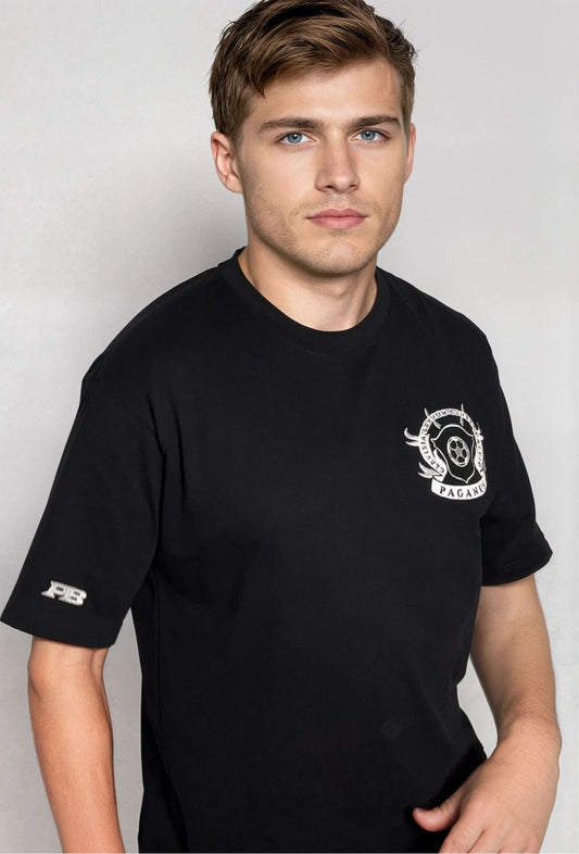 Man wearing a black t-shirt with logos on a plain background