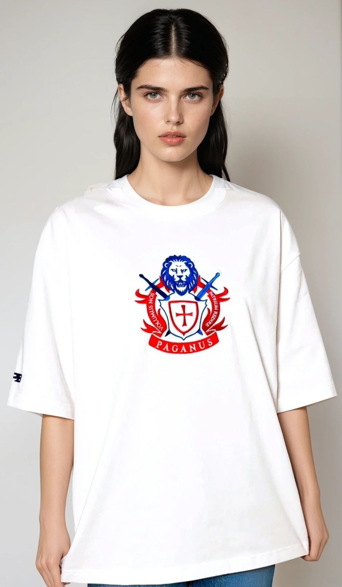 Model wearing a white t-shirt with a red and blue logo on a plain background